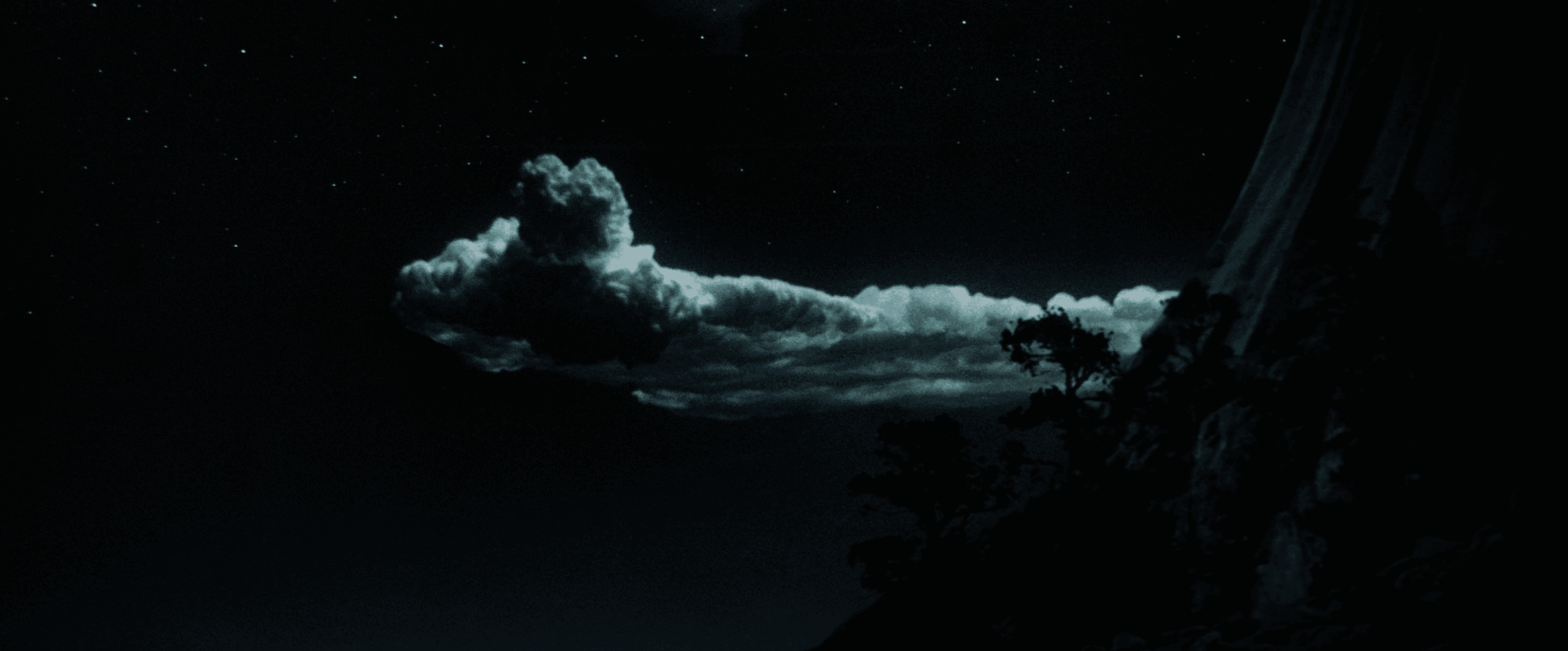 A still frame from the film "Close Encounters of the Third Kind" features a woman running in the grass with illuminated clouds overhead.