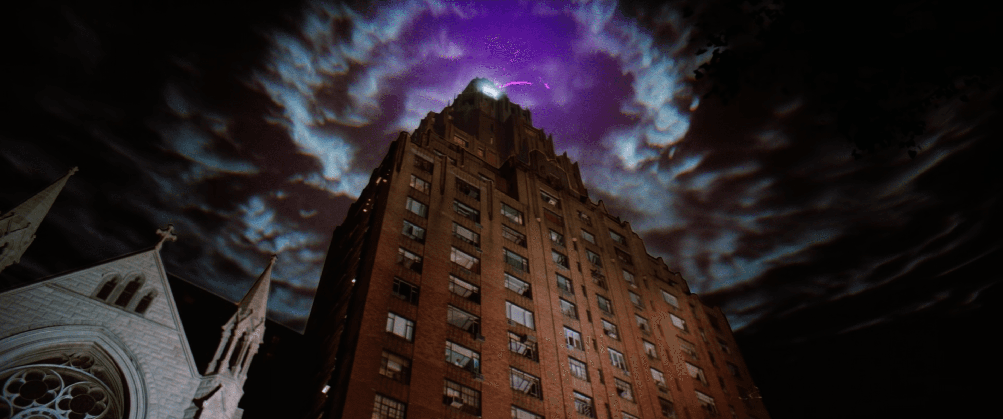 Look up at a skyscraper with ominous purple clouds overhead