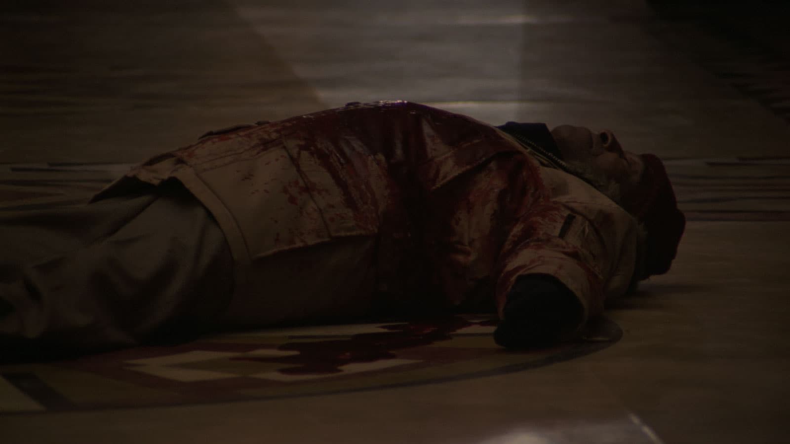 man laying on the ground covered in fake blood