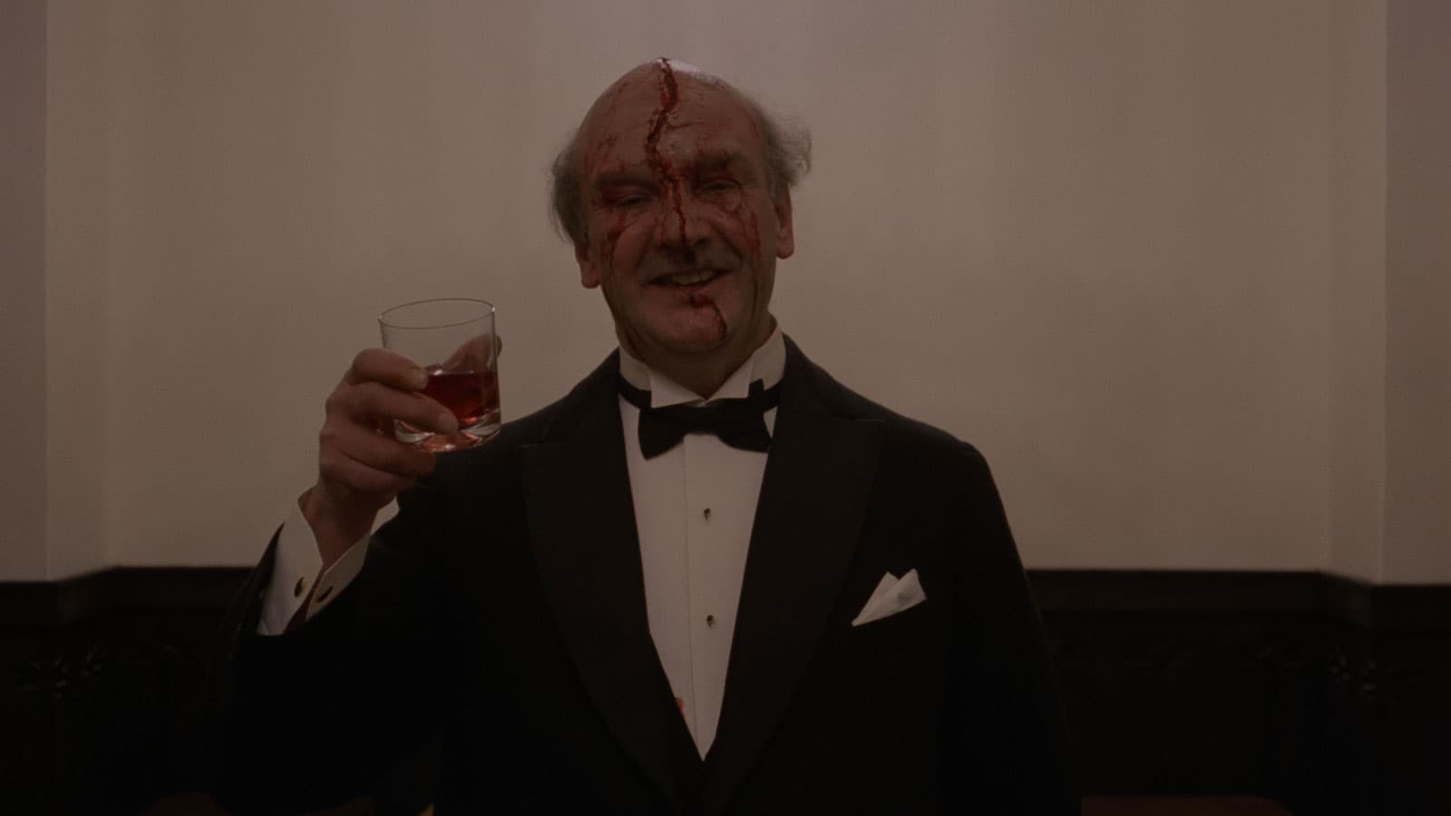 man in tuxedo with fake blood dripping from top of head