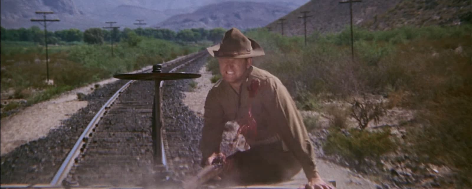 blood exits a man's chest from a gun shot